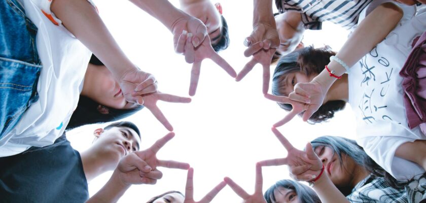 Group of People Forming Star Using Their Hands